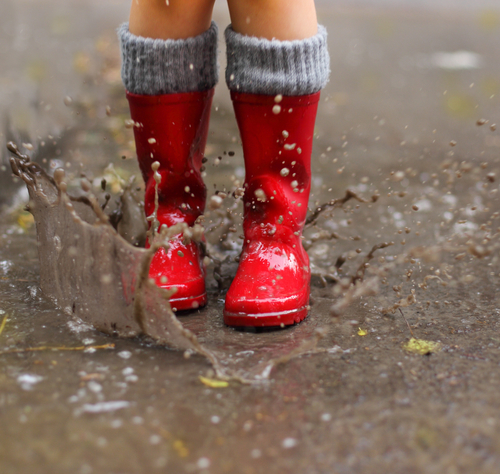 child wearing red wells